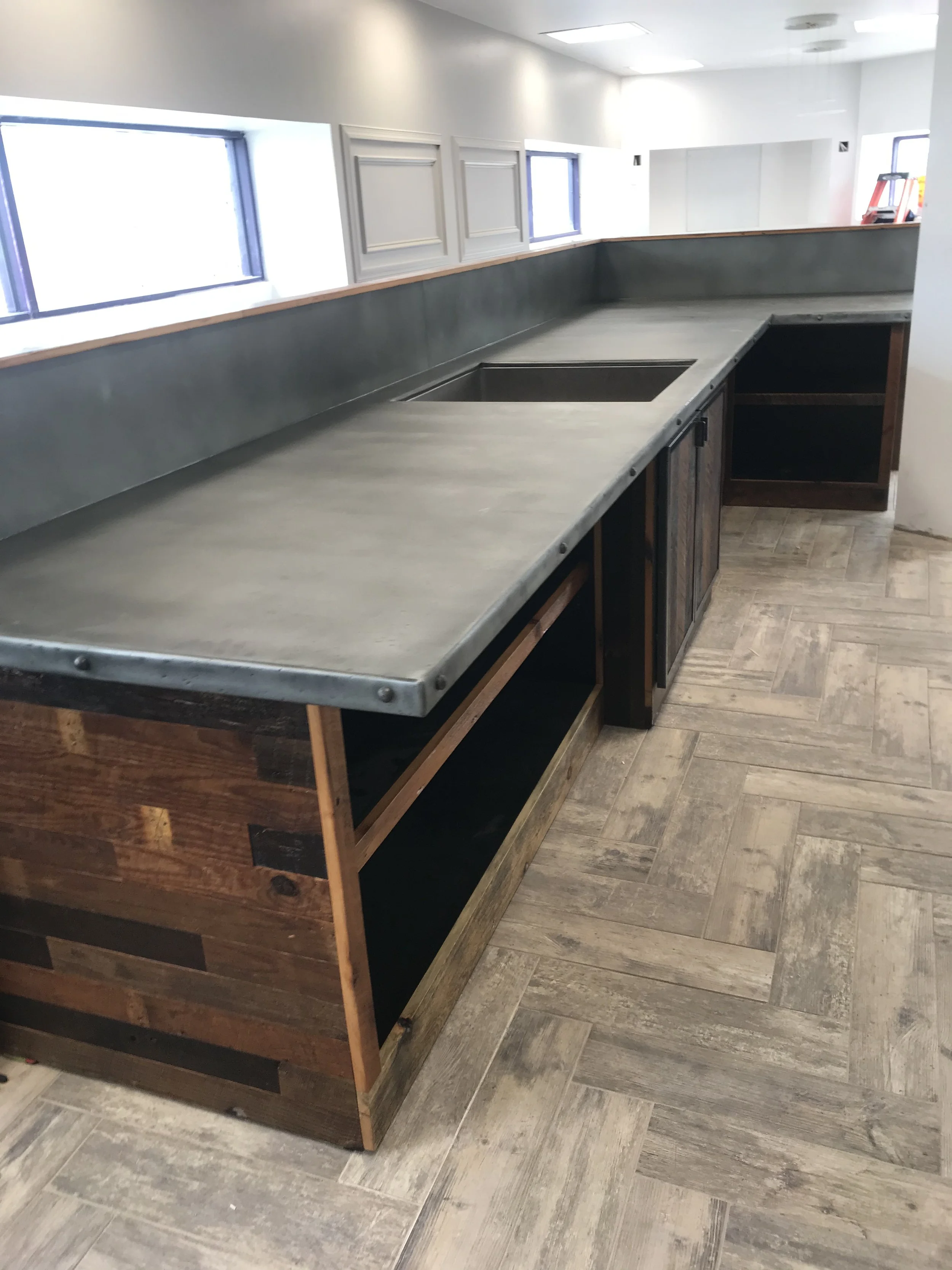 concrete look counter but better, patinas over time, interesting counters for retail space, woodworking metalworking baltimore maryland