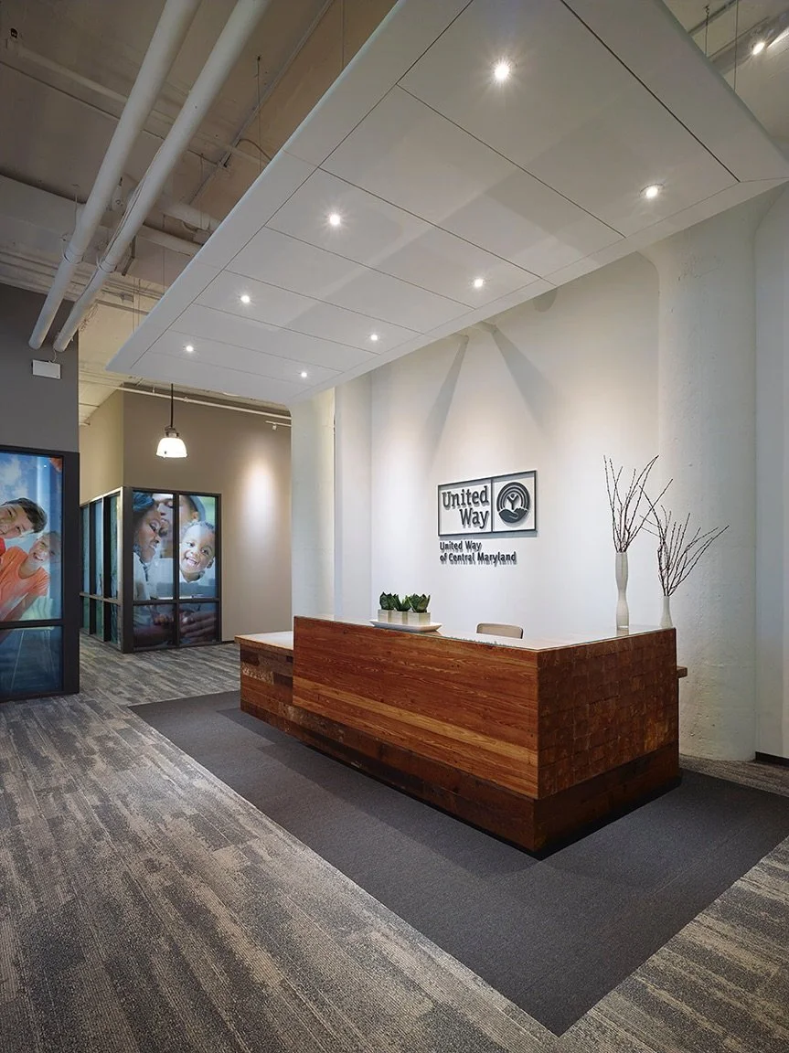 earthy warm modern reception desk with stone counters reclaimed wood