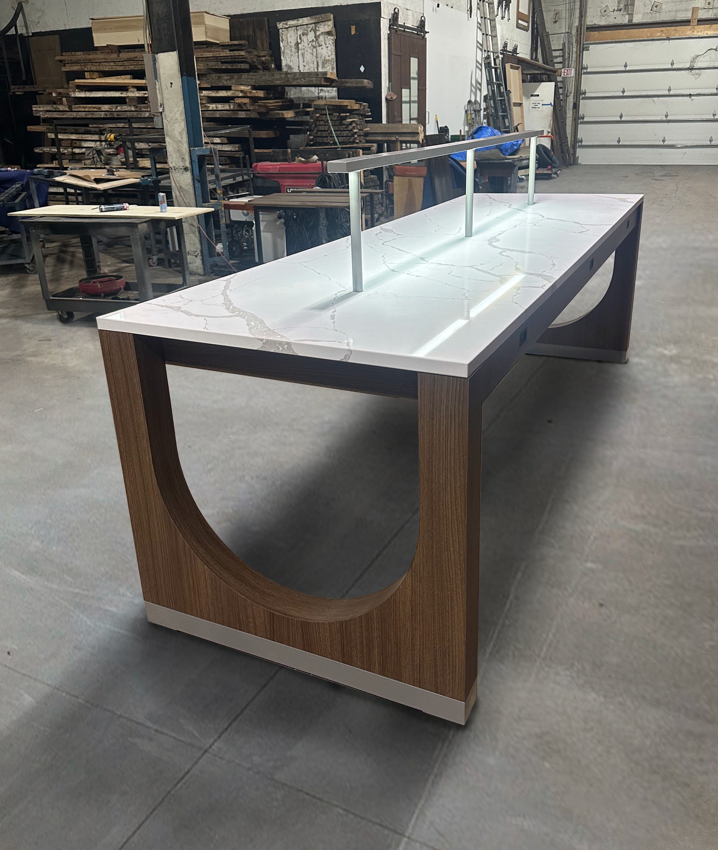 coworking table with stone top and custom light fixture, integrated outlets and cable management