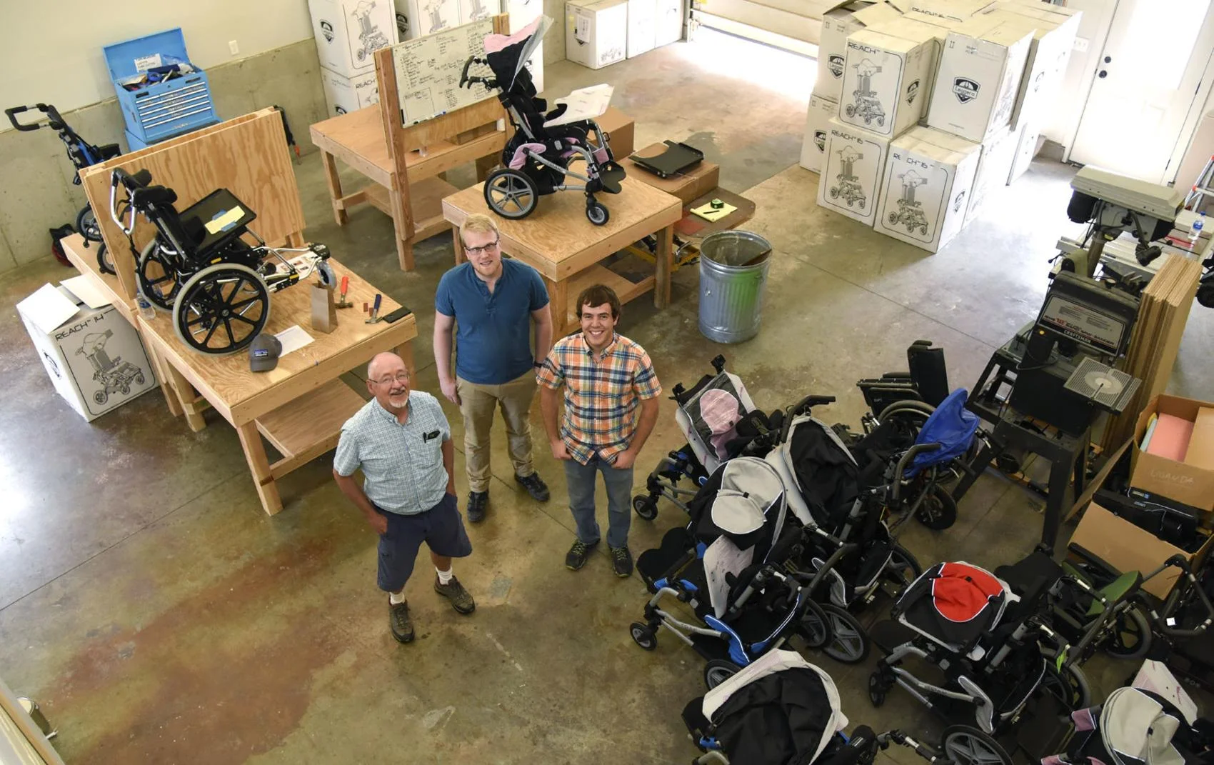 ROC Wheels co-founder Wayne Hanson, left, and two interns, Karl Swenson and Robert Knutson, stand in the middle of the nonprofit’s new headquarters on Thursday, May 31, 2018, in Four Corners