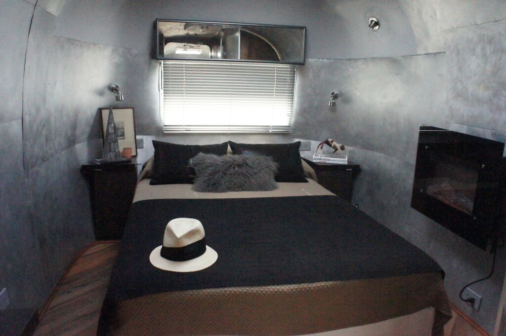Master Bedroom Suite features flatscreen television, electric fireplace and closet storage 