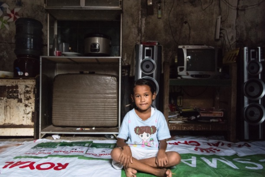 Ina, one of the luckier Bantar Gebang children, whose family have a small home with some concrete walls.