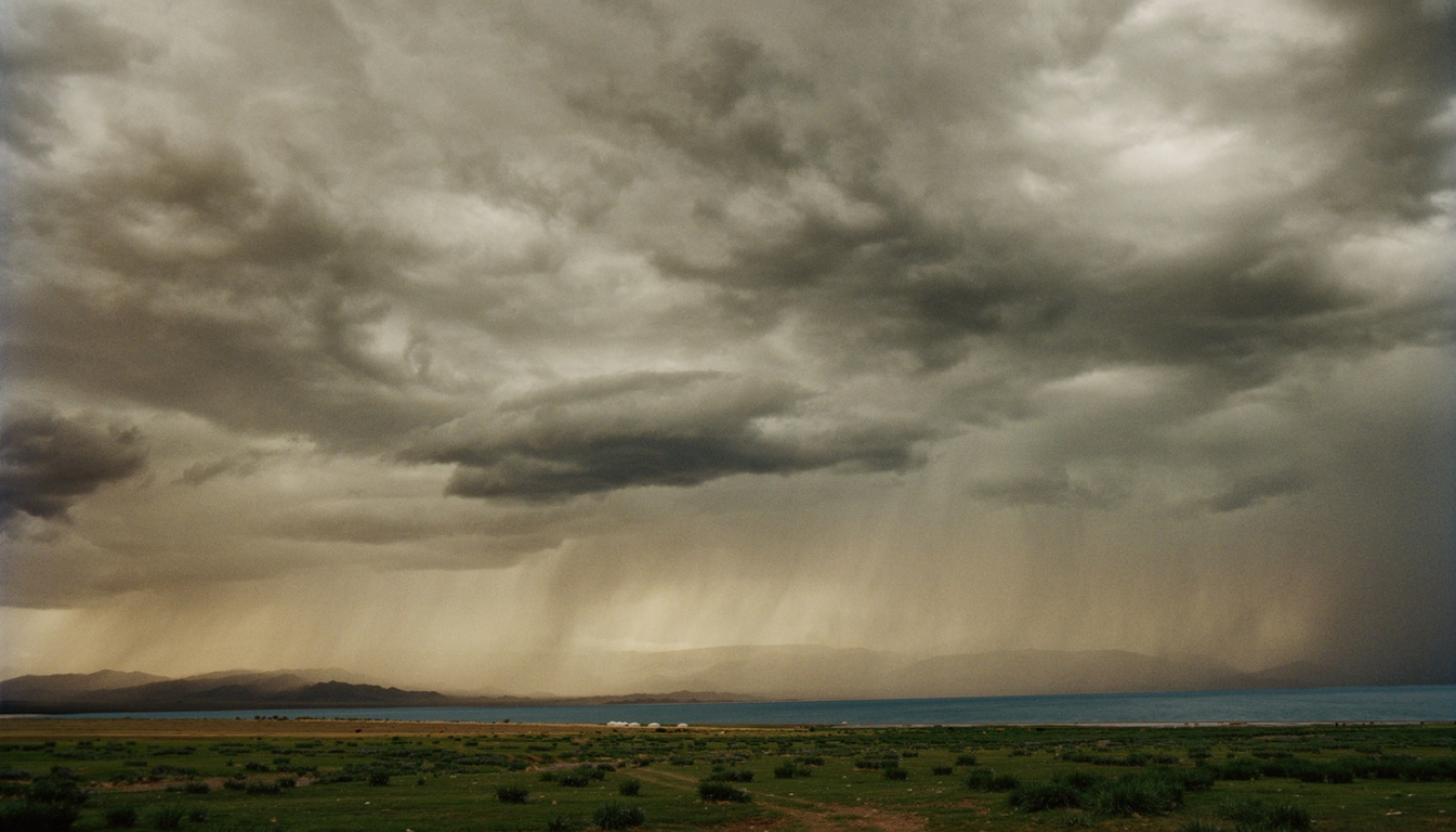 Illuminated bands of rain sweep towards a group of “ger” or yurts, huddled on the shores of Üüreg Lake (Үүрэг нуур) in western Mongolia.