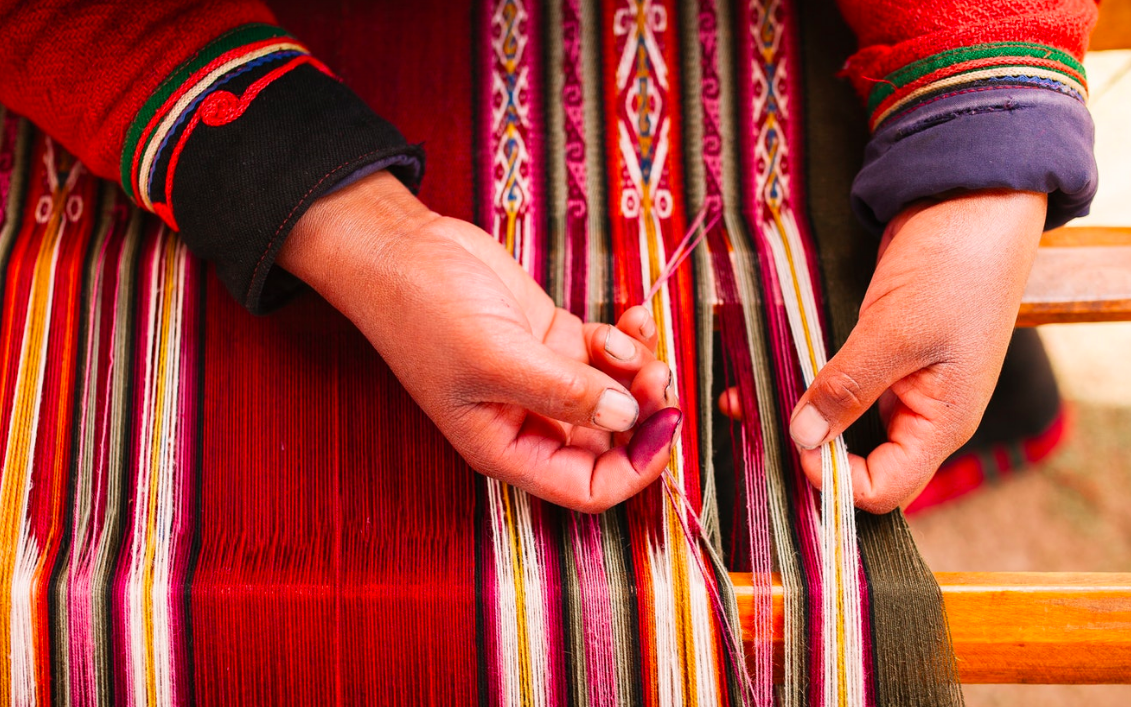 Above: Detail of Asunta, a young Andean weaver from a traditional Quechua community in the Piuray Lagoon weaving a new textile. Weaving is done using a simple backstrap loom, and the pattern design is woven only from memory.