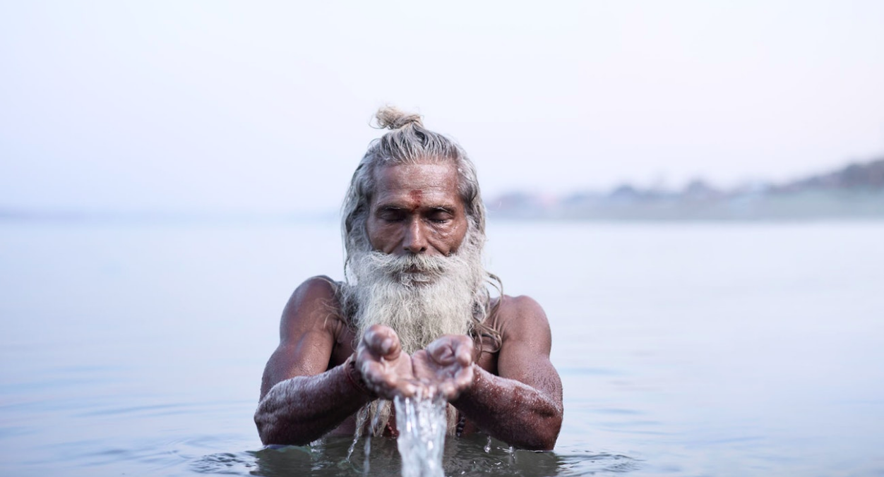 Above: Vijay Nund performing morning rituals in the Ganges River, the most sacred river in Hinduism.