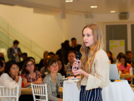 Photo of Kelley Louise speaking at 2017 Impact Travel Global Summit. Photo by Naomi Figueroa.