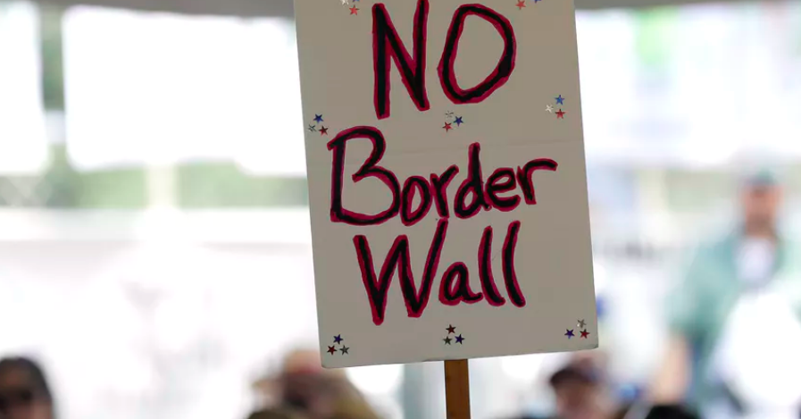 A ‘no border wall’ sign is held during a rally to oppose the wall the US government wants to build. AP Photo/Eric Gay