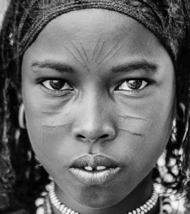 A young girl of the Afar tribe, from Ethiopia. Her people are fiercely proud and independent, having lived forever in the harsh deserts of the Horn of Africa, as semi-nomadic cattle and camel herders. Ethiopia