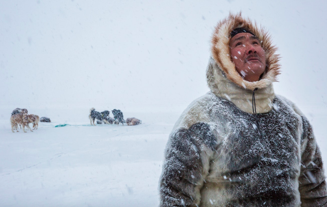 As he lifts his eyes to the falling snowflakes, Naimanngitsoq Kristiansen, a traditional Inuit hunter from Greenland, reminds me that nature is a spiritual sanctuary, made all the more hallowed by the first flurry of snow in Spring. Greenland