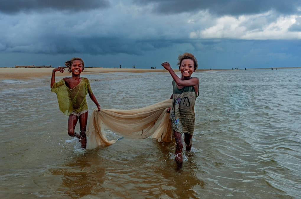 Two young Vezo girls, like water nymphs more at home in the ocean than on land, gather fish for their family’s dinner. Madagascar