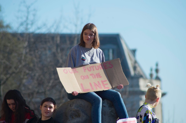 Photo of a student protester. By Josh Barwick on Unsplash .