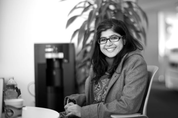 Khalida Brohi sitting at a table, smiling. Joi Ito. CC 2.0