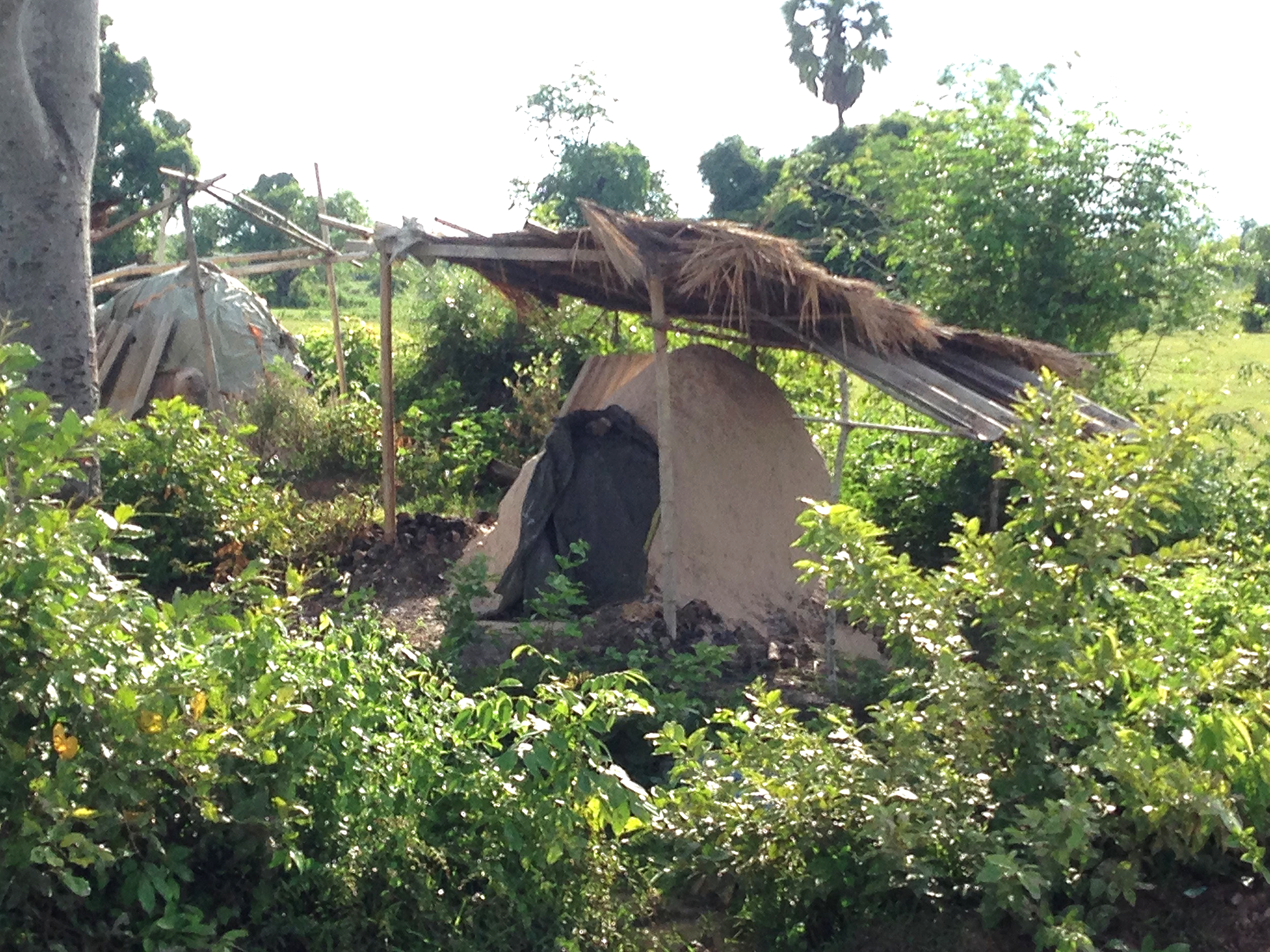Charcoal huts - a common sight - where charcoal is made by burning wood.