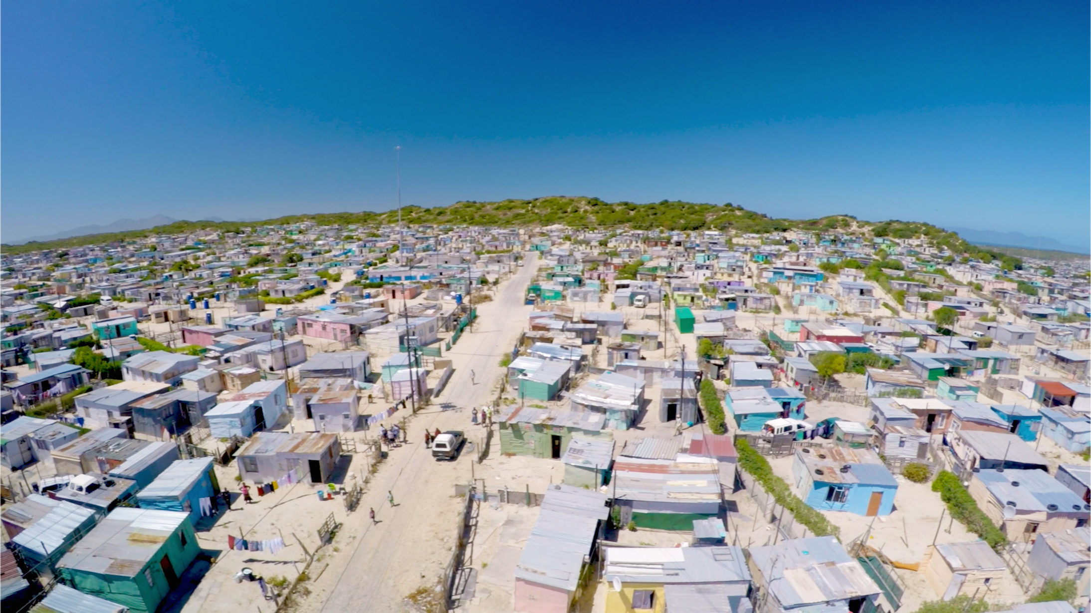 Aerial shot of Khayelitsha. Khayelitsha is home to an estimated 1-2 million people. T he unemployment rate is roughly 40%, with 55% of the population living in informal shack housing