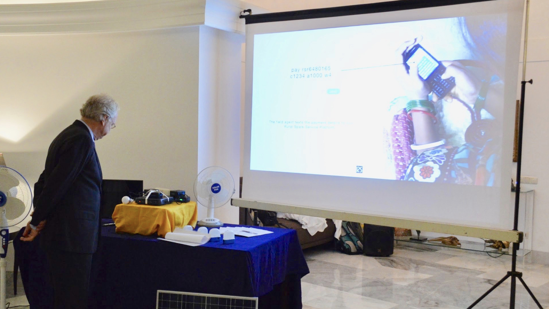 Dutch Ambassador Alphonso Stoeling about to activate the Rural Spark Energy Router after receiving a activation text message. 