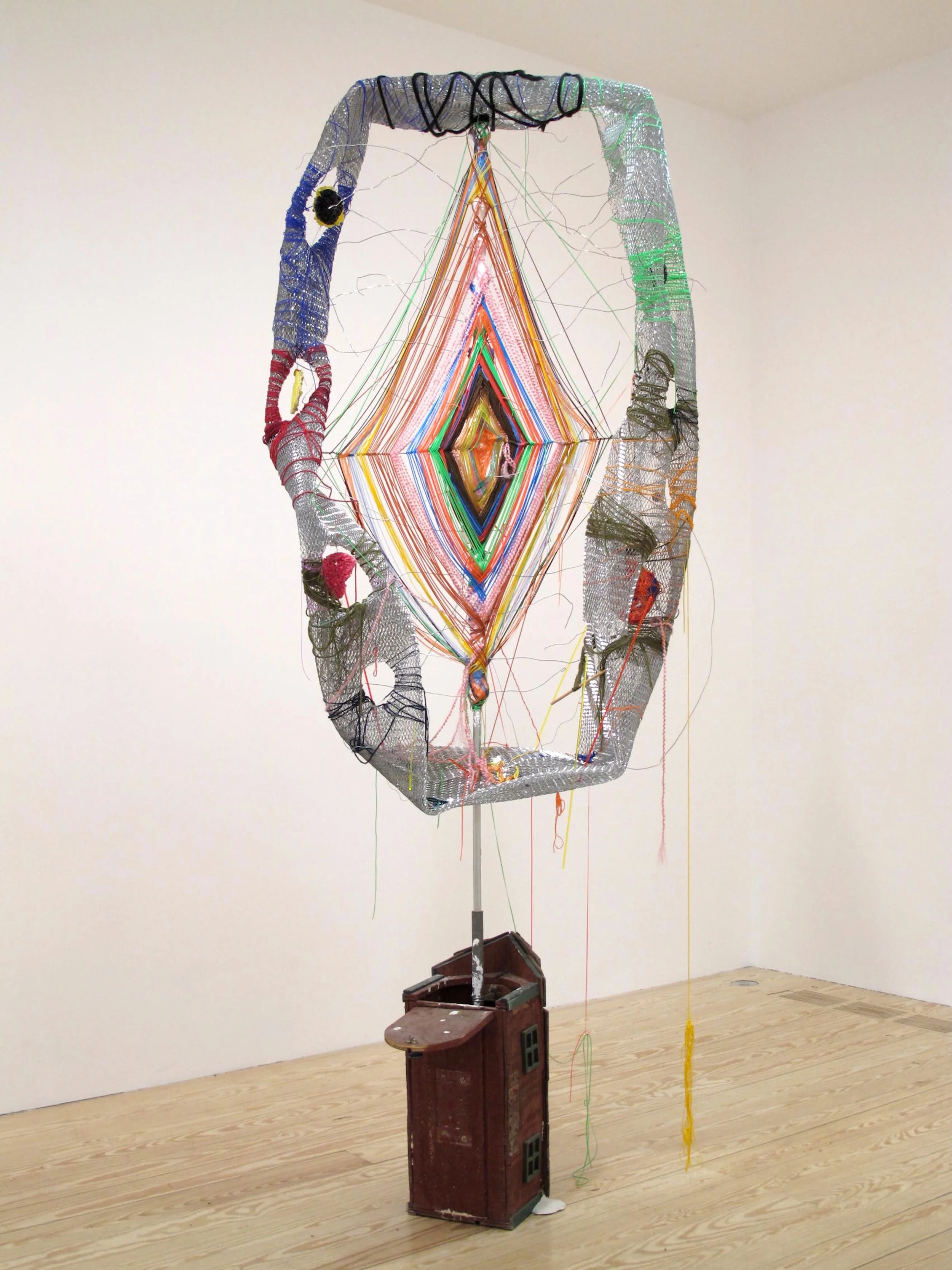Godzeye, 2011. 102" x 42" x 35" Metal, plastic lace, yarn, string, rocks, acrylic, modeling clay, plaster, papier-maché, mailbox.