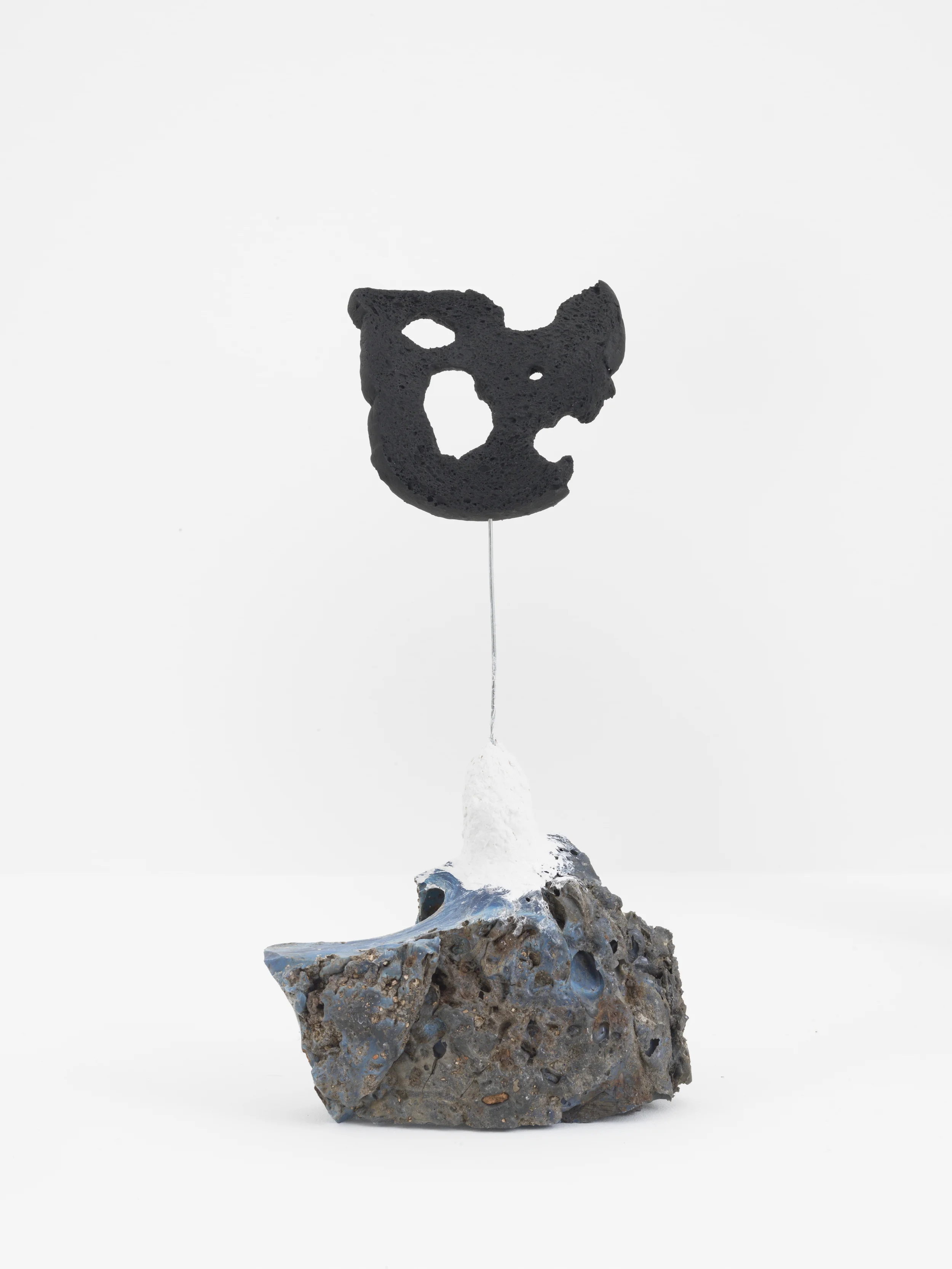 Driftloaf (Black on Slag), 2015. Slag, papier-mâché, wire, bread, paint, 12.5 x 7 x 3 inches