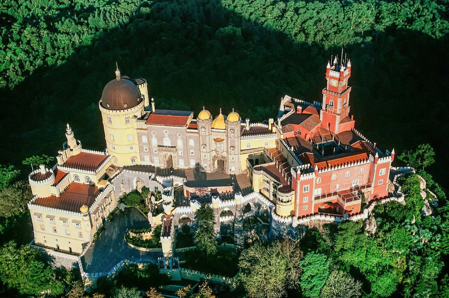 An aerial photo of Pena National Palace, Sintra, Portugal.  Renowned for its eclectic architecture, ornate interiors, and panoramic views of the surrounding landscape.