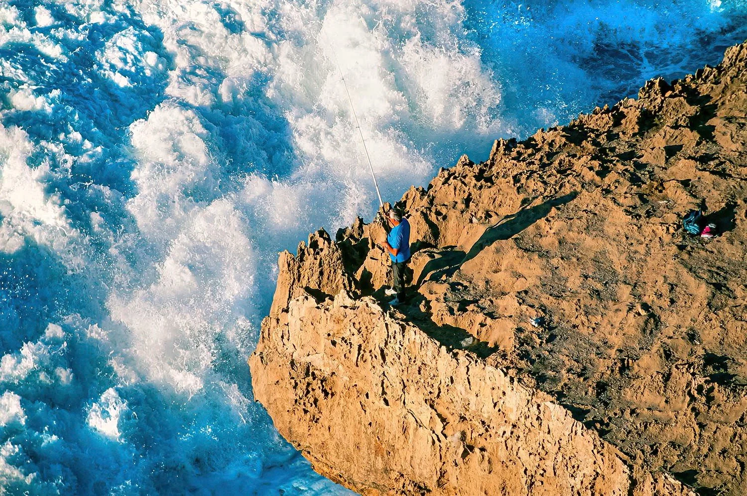 An aerial photo of a lone fisherman, Portugal