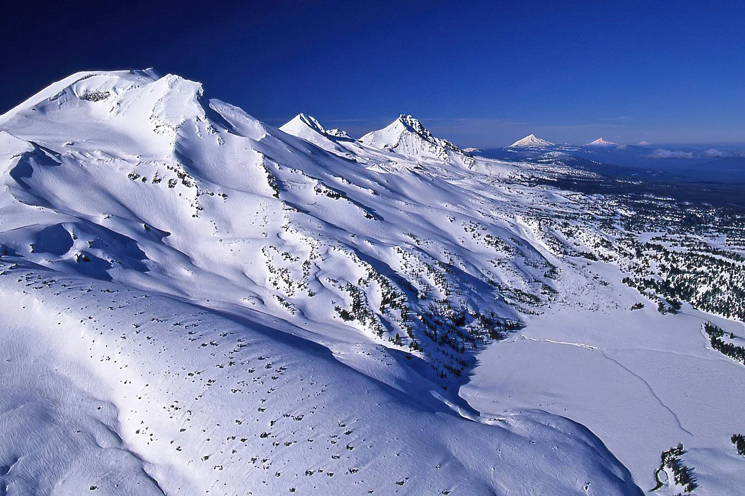 An aerial photo of the Three Sisters, Oregon looking north into Washington. USA.  The Three Sisters are a trio of volcanic peaks in the Cascade Range.