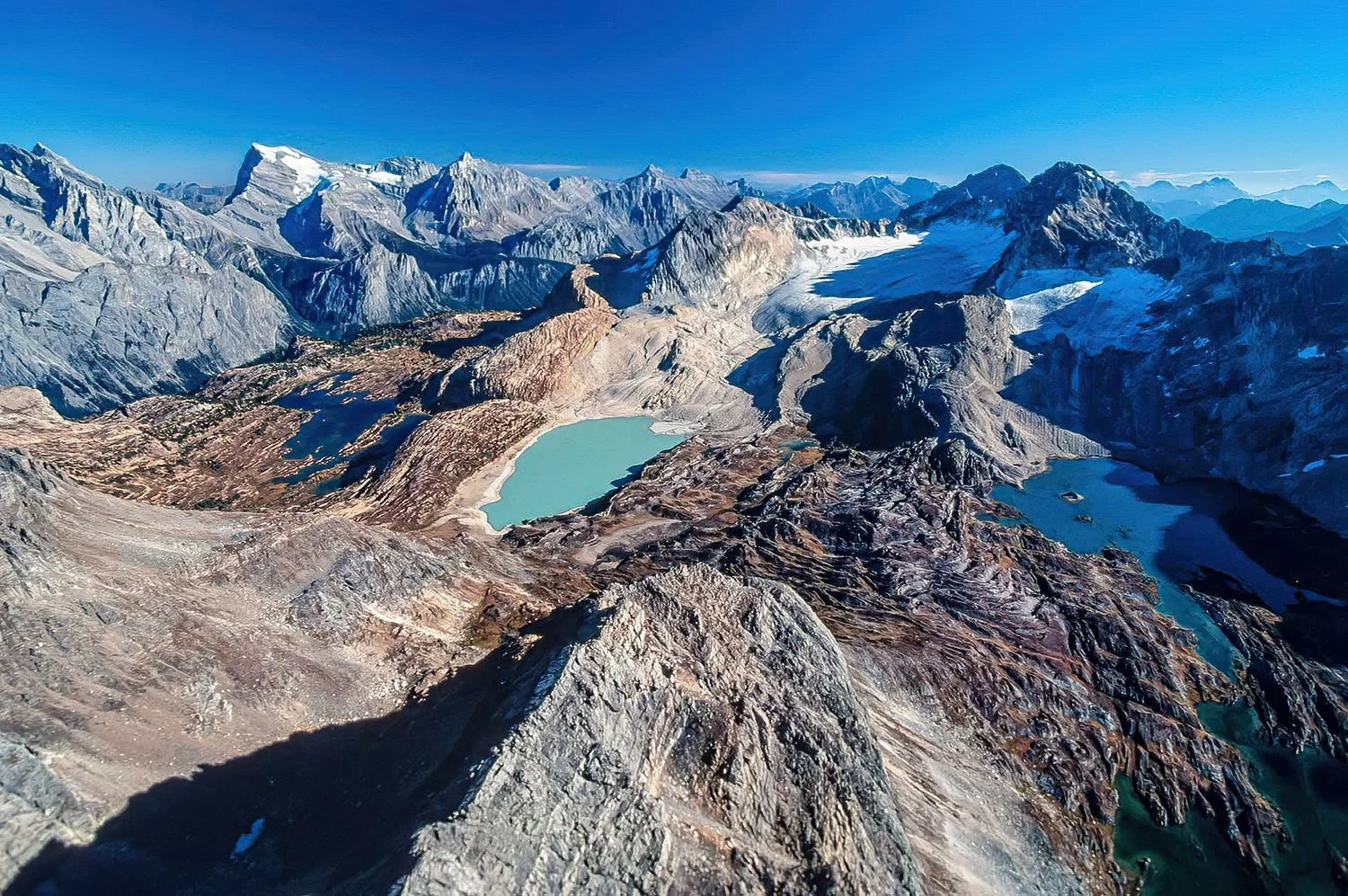 An aerial photo of the Height of the Rockies Provincial Park, BC, Canada.  A remote wilderness park known for its dramatic alpine peaks, glacier-fed valleys, and exceptional wildlife habitat.