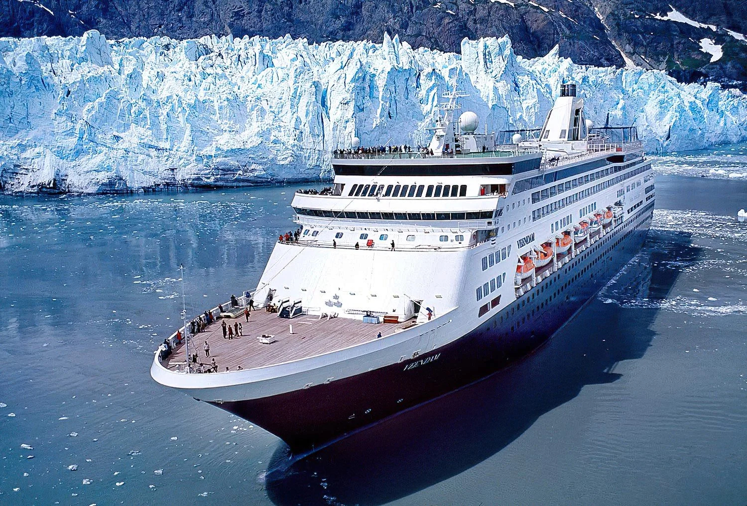 An aerial photo of Glacier Bay National Park, Alaska, USA.  The Veendam sails through Alaska, offering stunning views of towering glaciers, icy fjords, and abundant wildlife along the rugged coast.