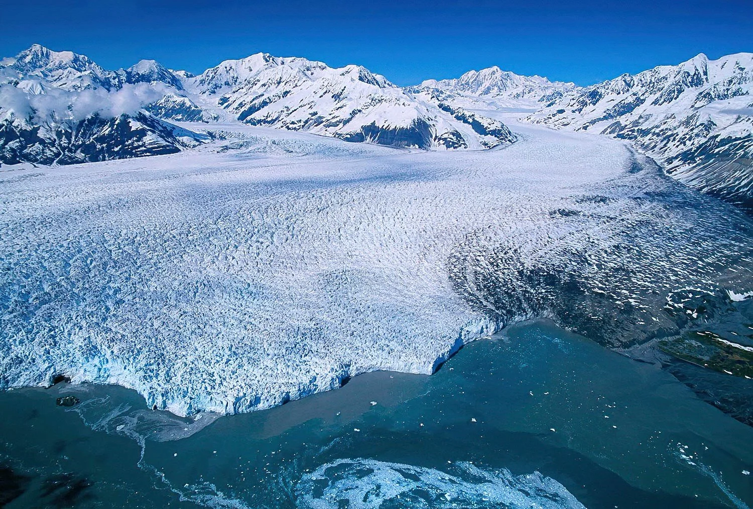 An aerial photo of the Hubbard Glacier, Alaska, USA.  The Hubbard Glacier is a massive tidewater glacier, famous for its advancing ice front, dramatic calving, and striking blue ice.