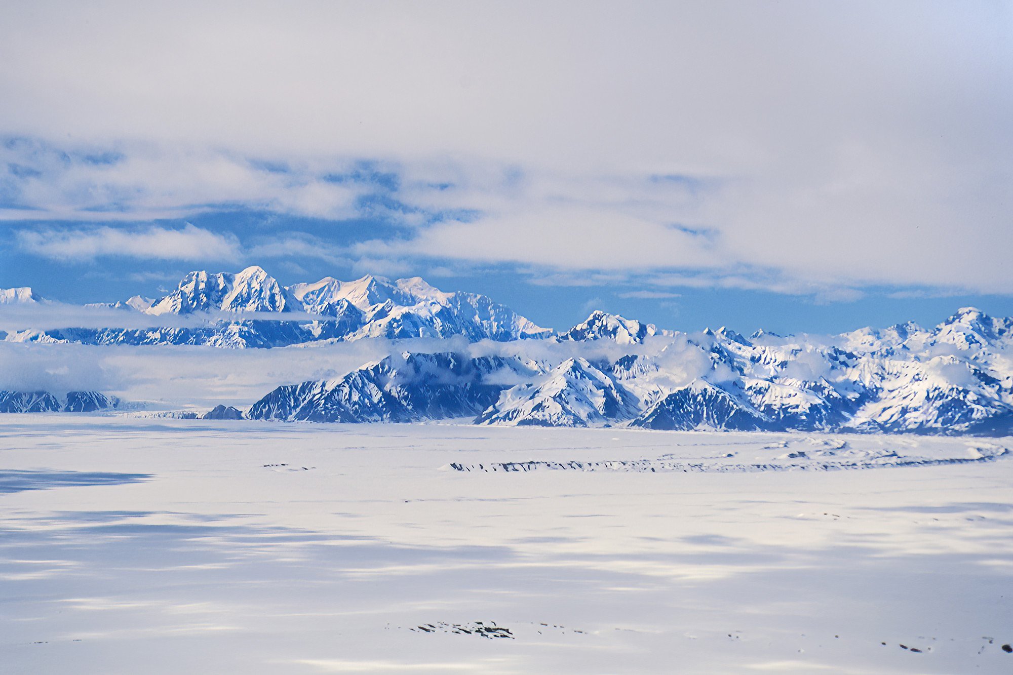 Transiting the vast Malaspina Glacier, Alaska, USA.  One of the largest piedmont glaciers in the world, where massive rivers of ice spill out of the mountains and spread across the coastal plain.