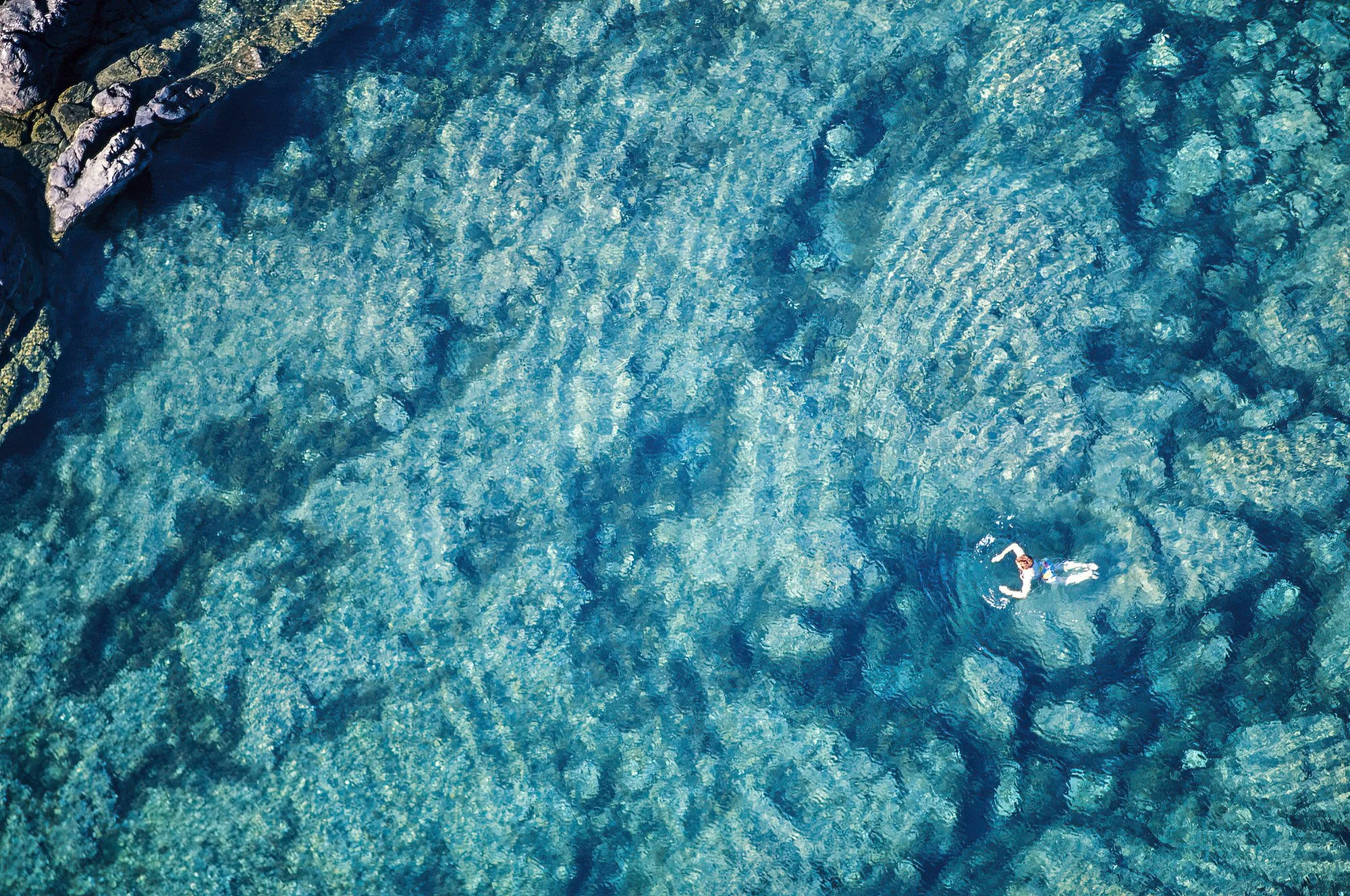 An aerial photo  of swimming in the saltwater pools of Porto Moniz, Madeira, Portugal