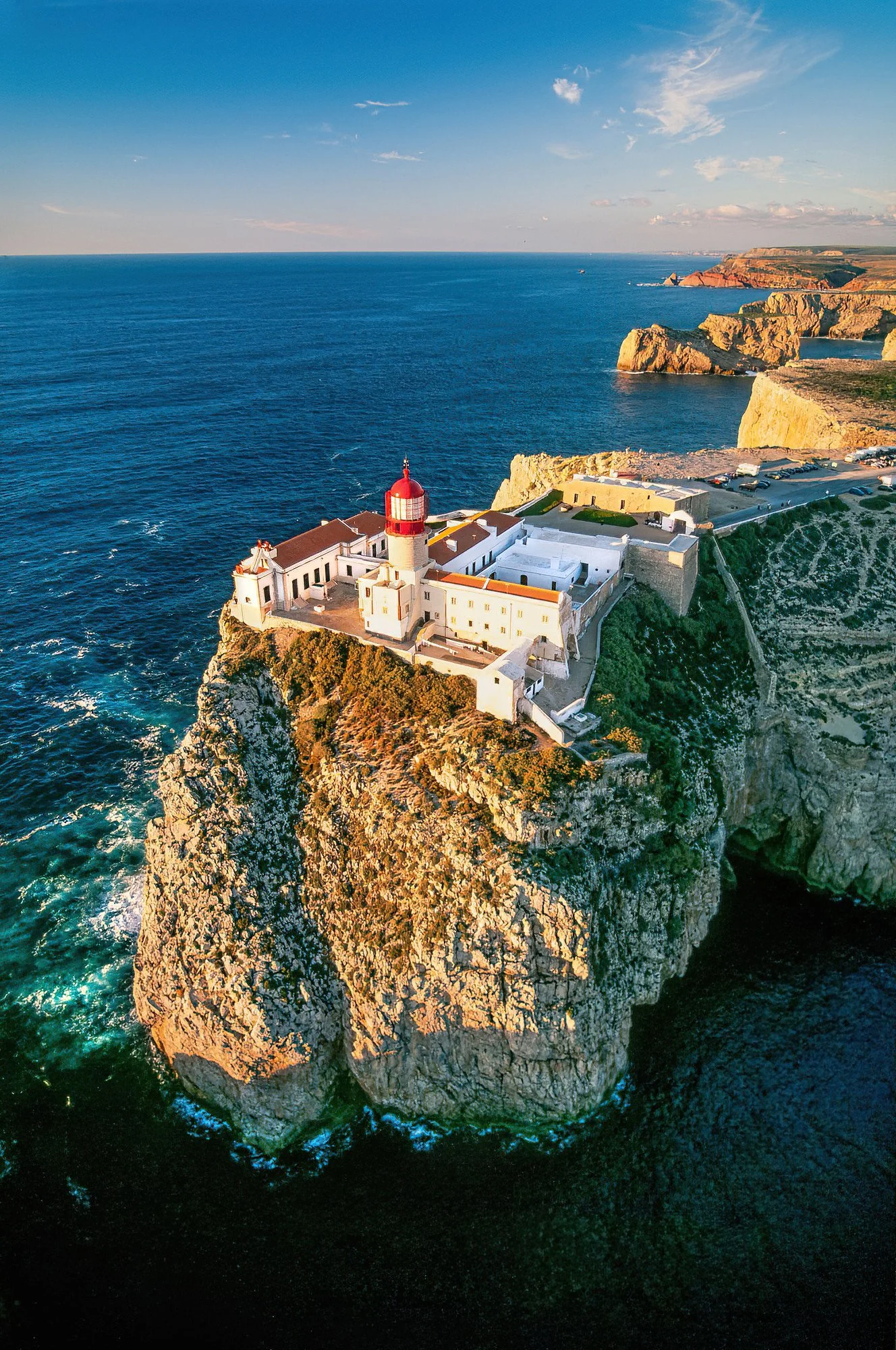 An aerial photo of Cabo De Sao Vicente, Sagres, Portugal.  Cabo de São Vicente is a dramatic southwestern cliff famous for its historic lighthouse, rugged scenery, and stunning sunsets.