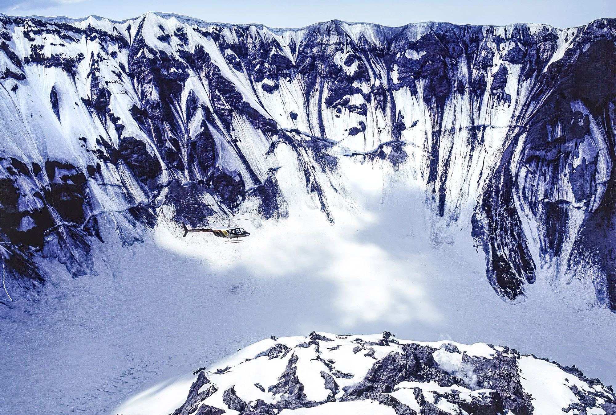 An aerial photo taken inside the Mount St. Helens volcano, Washington, USA.  Steam and gas emissions are seen rising from the crater floor and dome—indicating ongoing volcanic and geothermal activity.