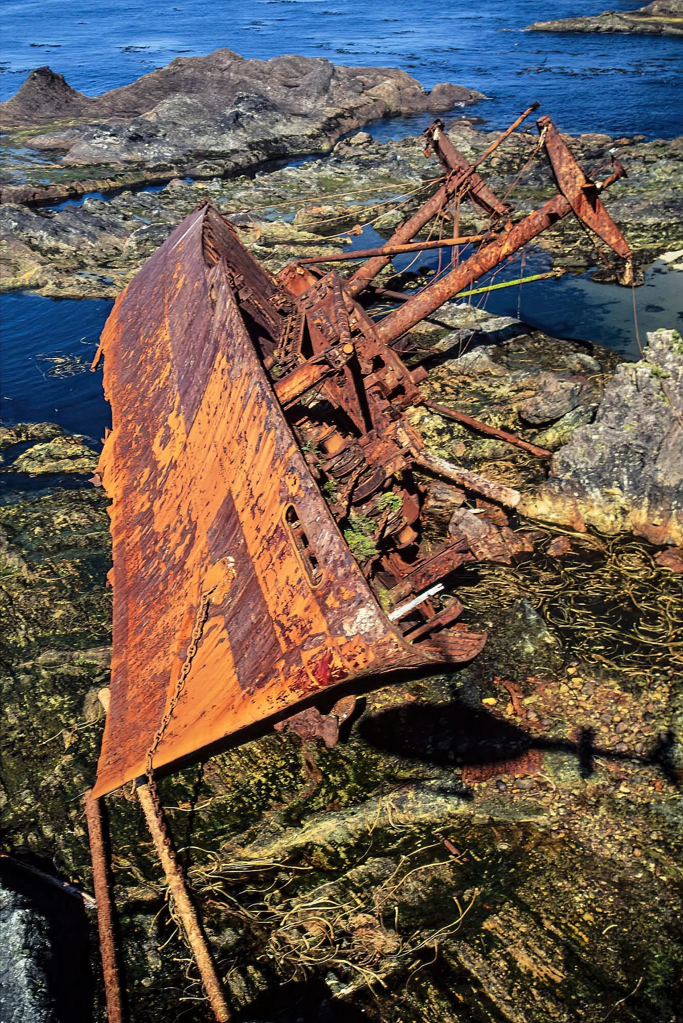 An aerial photo of the USATS Clarksdale Victory wrecked on Hippa Island, BC, Canada.  A World War II-era cargo vessel that now serves as a haunting landmark amid the rugged coastal scenery of BC.