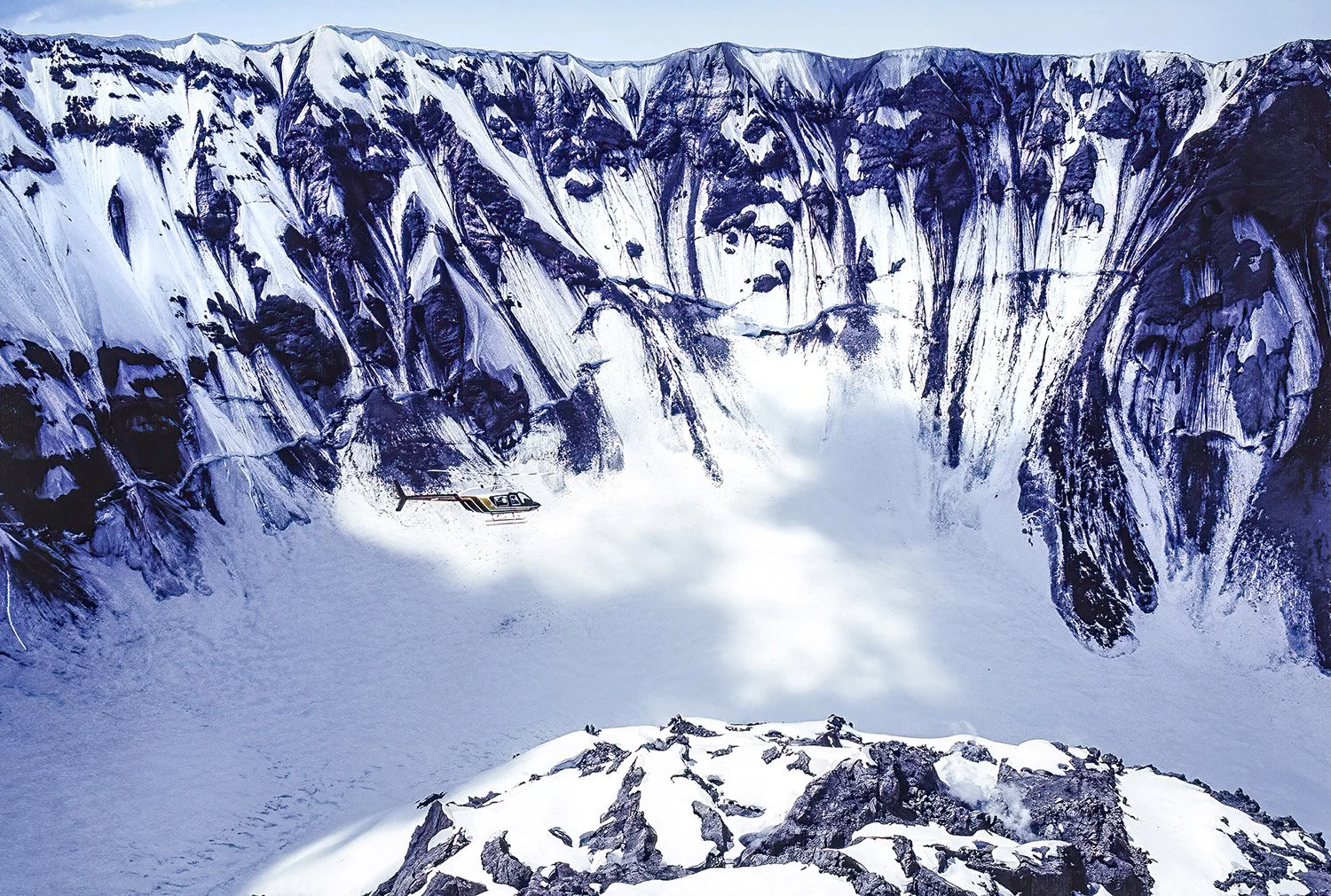 An aerial photo taken inside the Mount St. Helens volcano, Washington, USA.  Steam and gas emissions are seen rising from the crater floor and dome—indicating ongoing volcanic and geothermal activity.