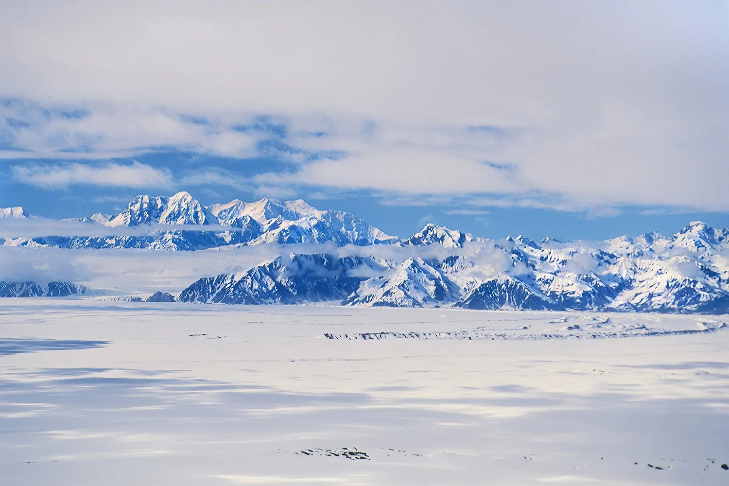 Transiting the vast Malaspina Glacier, Alaska, USA.  One of the largest piedmont glaciers in the world, where massive rivers of ice spill out of the mountains and spread across the coastal plain.