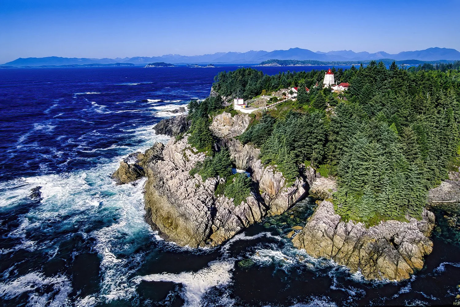 An aerial photo of Cape Beale Lighthouse, Vancouver Island, BC, Canada.  It  is a historic coastal lighthouse known for its remote location and scenic ocean views.