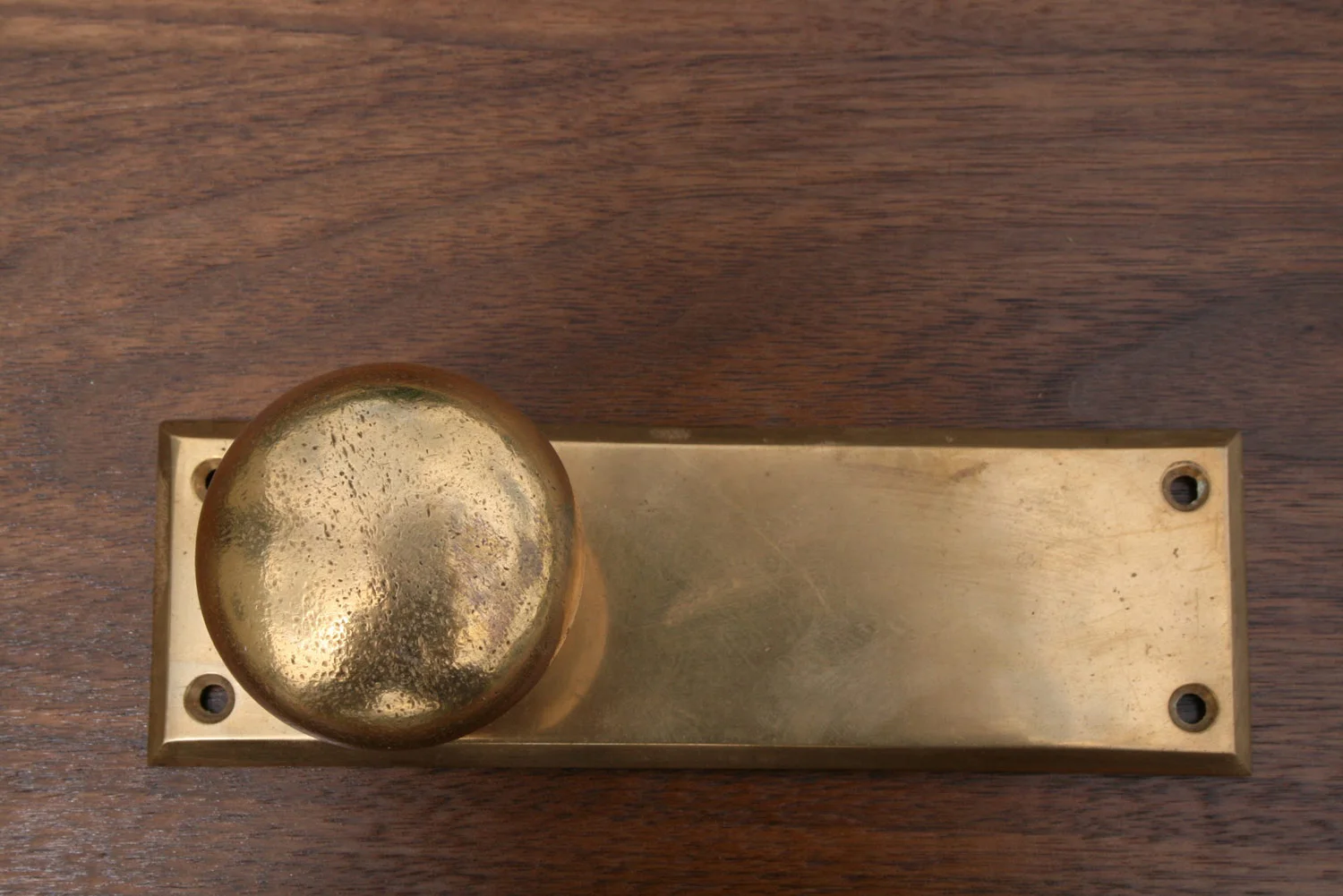 Salvaged bronze doorknob on walnut door by Allan Shope