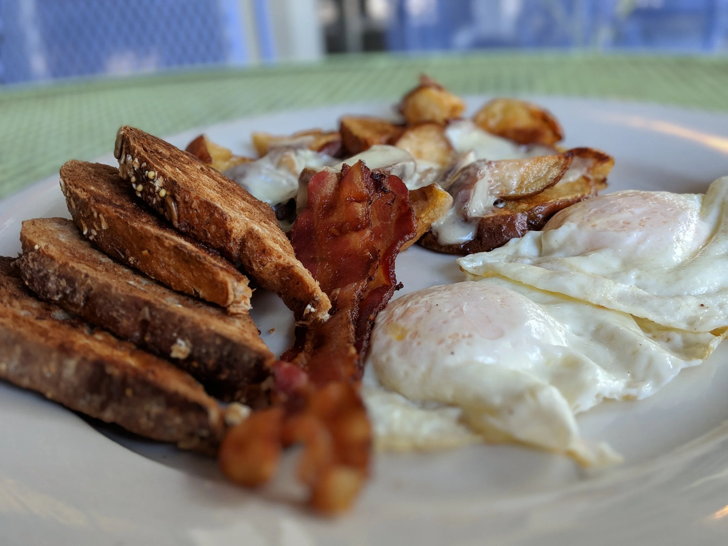 Beach Bum Bagel Cafe Presents : 2 Eggs Medium, Bacon, Cheese Home Fries and Multigrain Toast