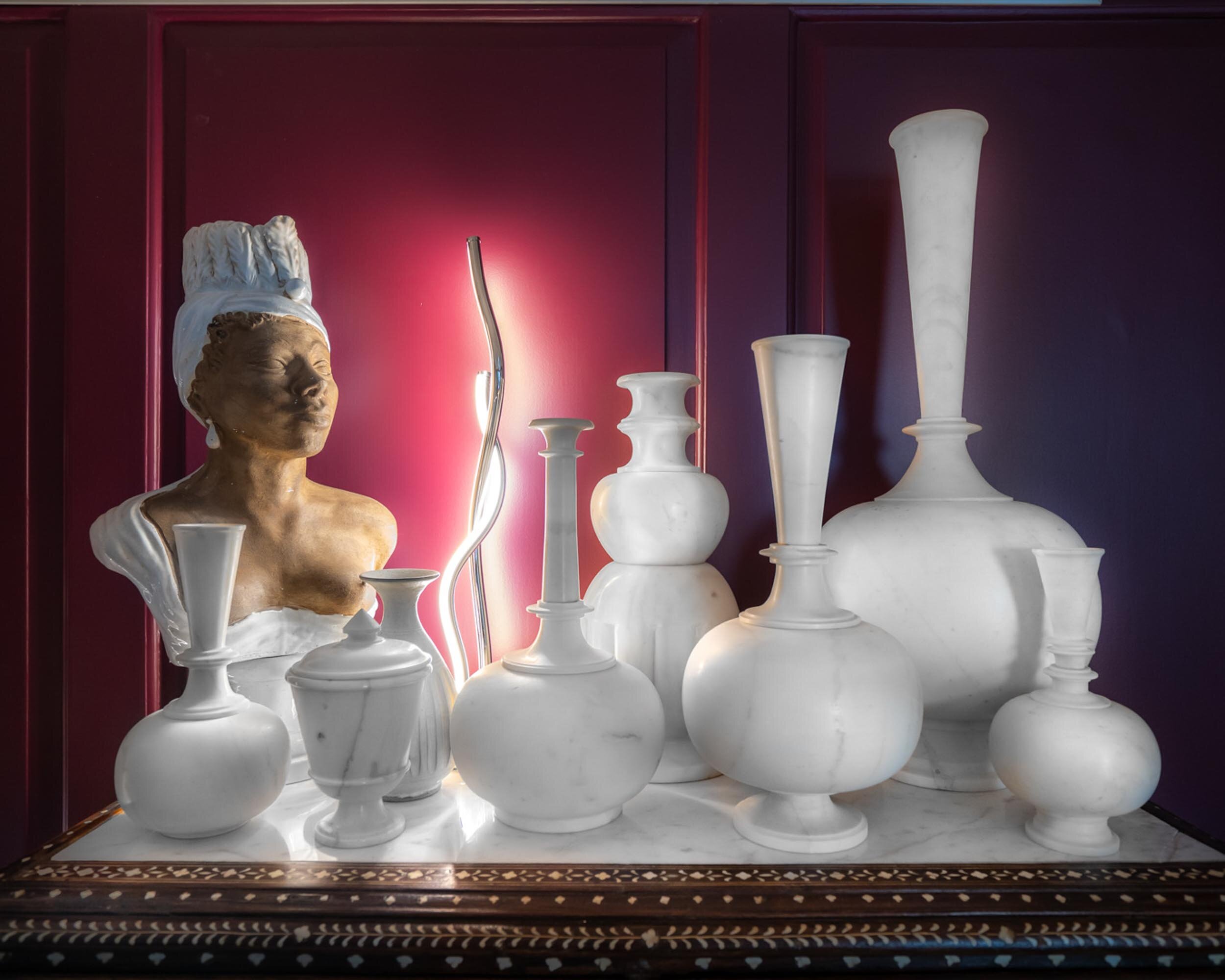  #bradsteinphoto, Highlights from the #kipsbayshowhouse19 @vicentewolfdesigns creative bathing/lounging area, aubergine walls is the backdrop for a wonderful collection of marble vessels crowd around a 1940s bust of a woman atop an inlaid Indian ches