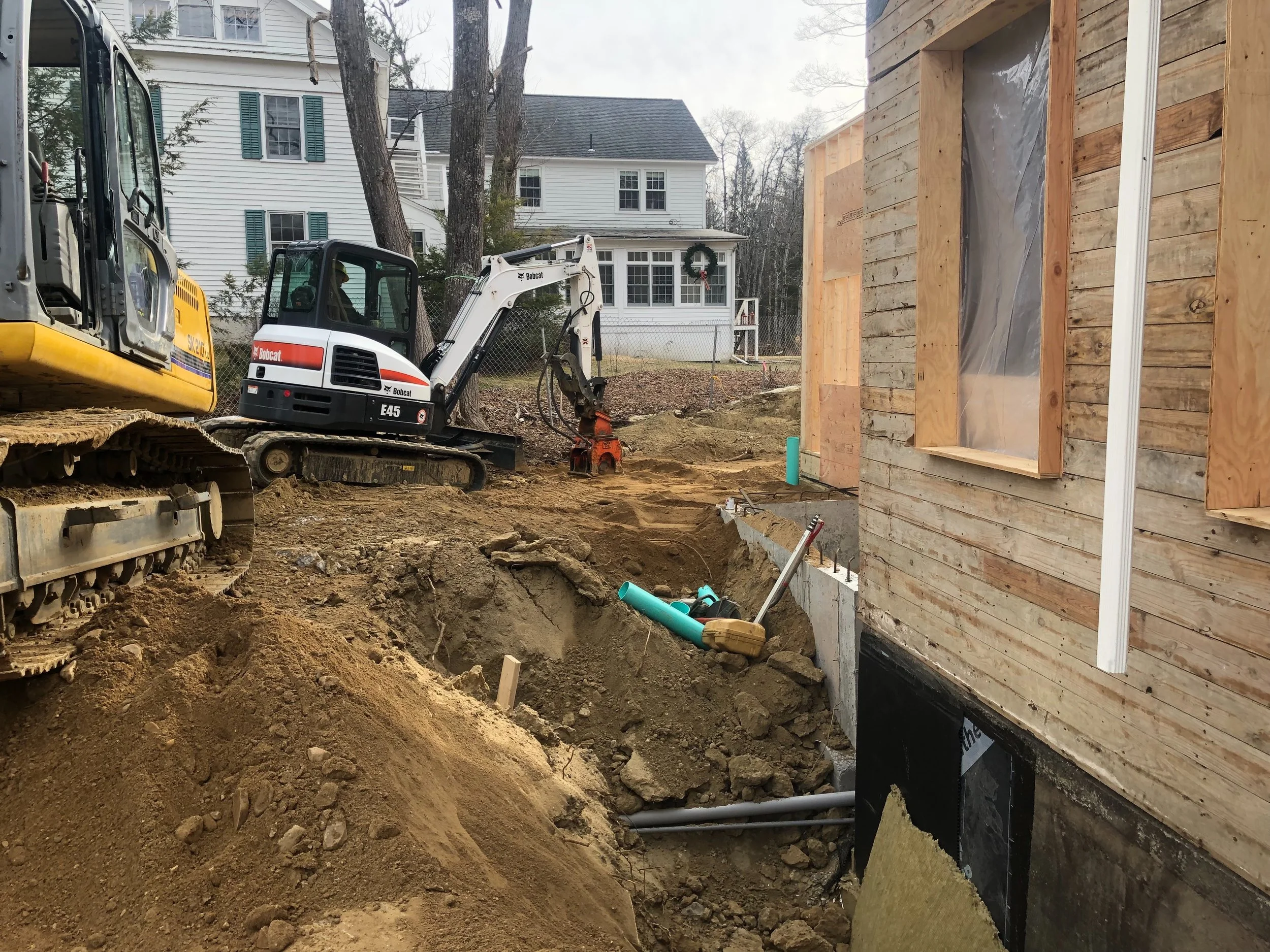 BACKFILLING AR0UND FRONT OF ADDITION