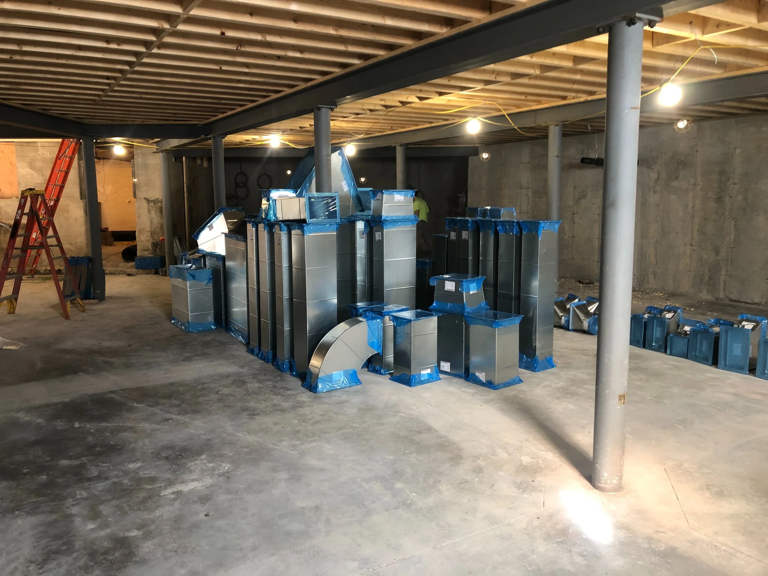 NEW BASEMENT FLOOR A GOOD SPOT TO STORE THE PREFABRICATED DUCTWORK