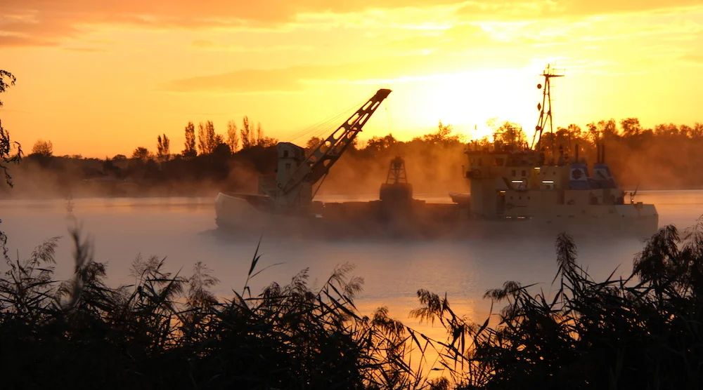 A boat in early morning mist on the Dordogne in Bordeaux, September.
