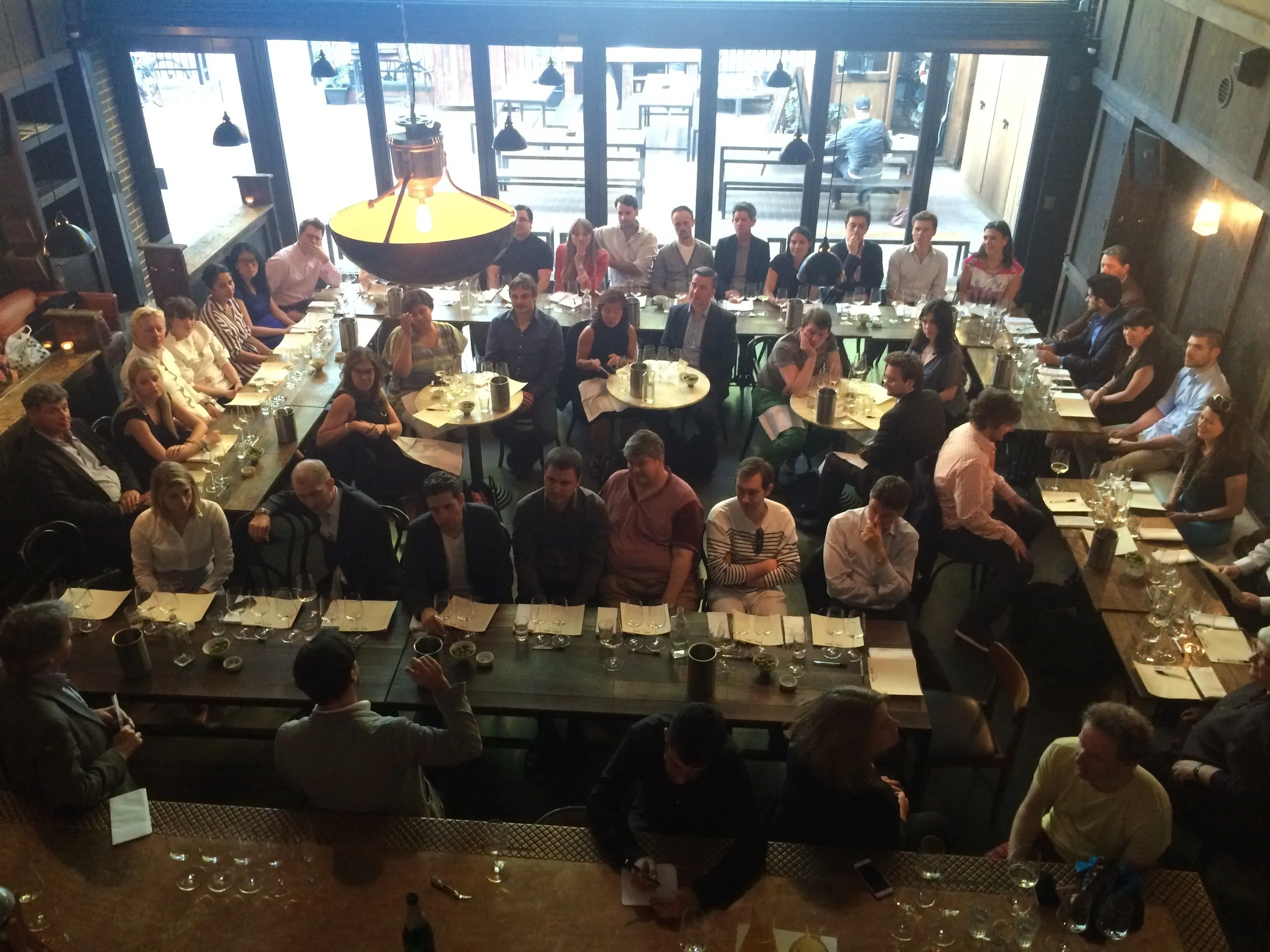 Michael Sager-Wilde (hand raised) addresses the crowd of tasters