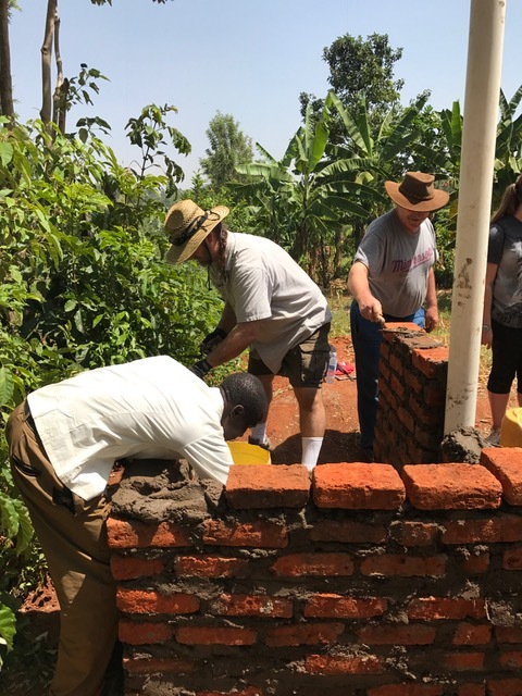 Dennis and Randy Darling building the another widow's outhouse.