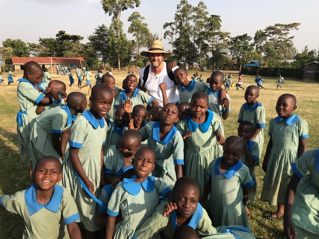 Denis loving on the kids at the school, the kids love him!