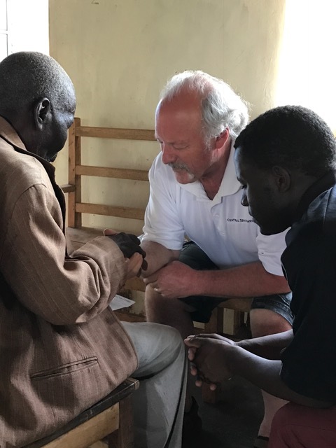 Randy praying for patients at the medical clinic.