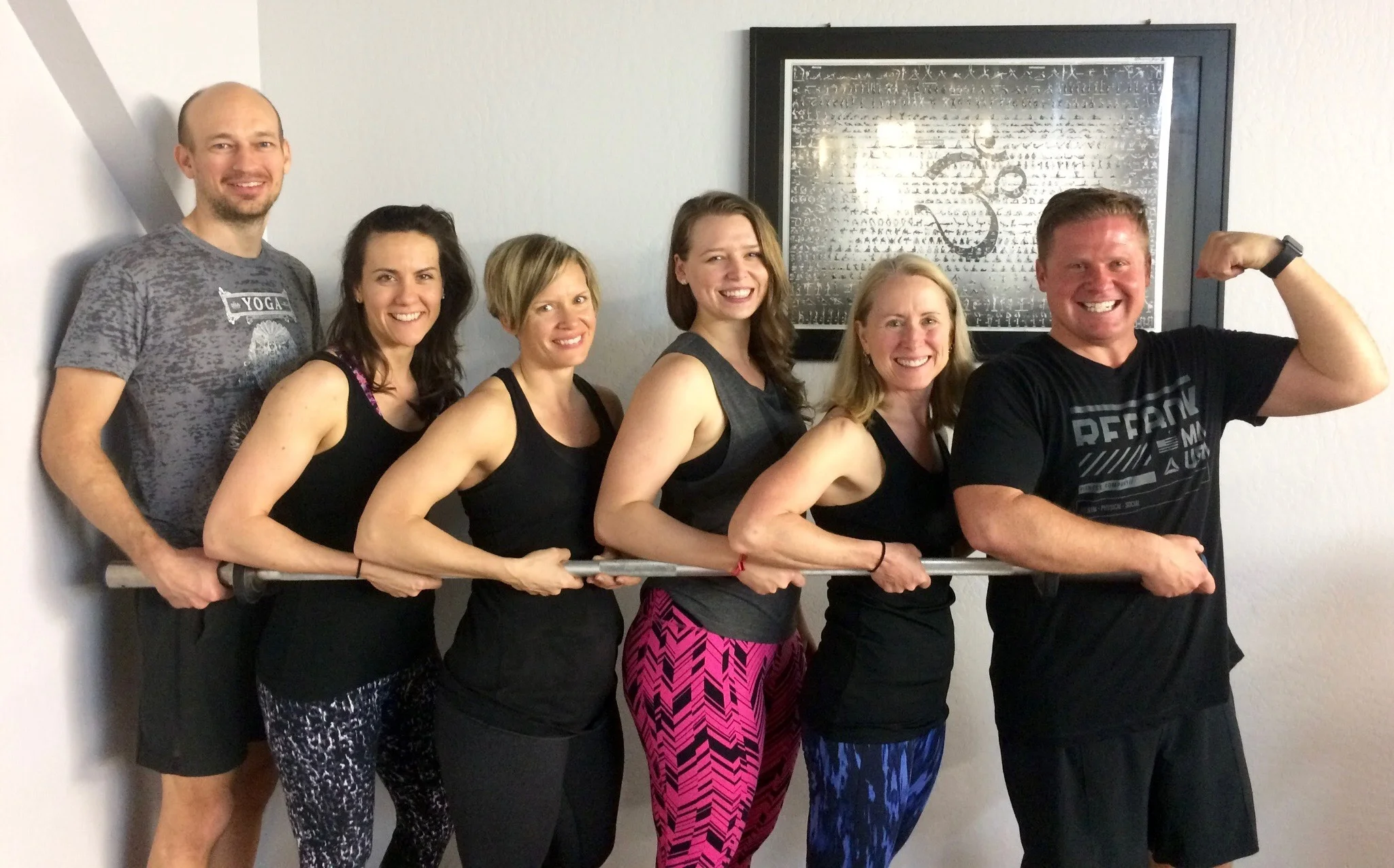 Brendan Lentz (left) and Dawn Baumgartner (second from left) with Dharma Yoga students at Crossfit Back on the Bar