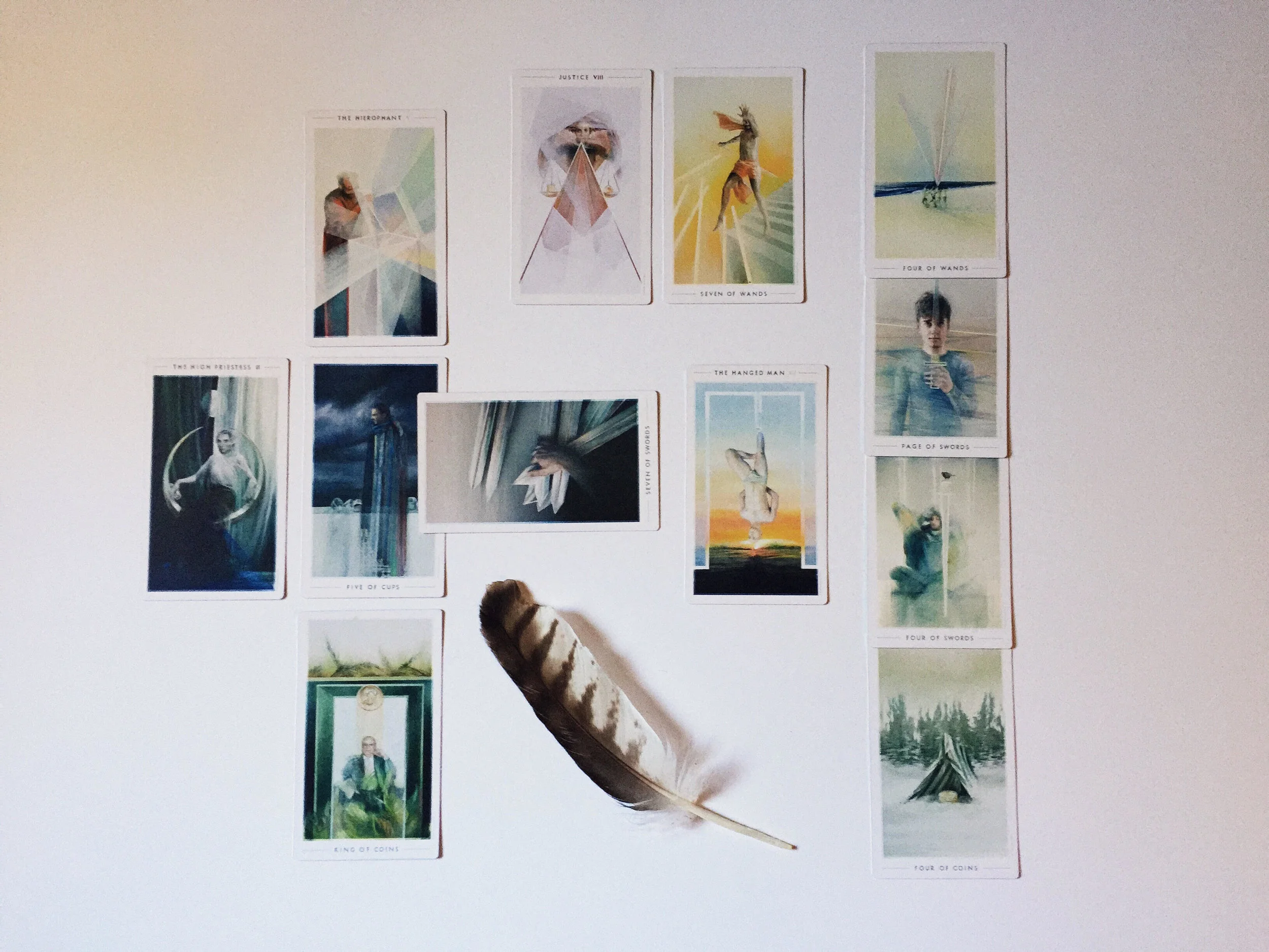 In order: Five of Cups (Situation), Seven of Swords (Challenge), King of Coins (Root or Cause), The High Priestess (Recent Past), The Hierophant (Best Outcome), The Hanged Man (Near Future), Four of Coins (Self), Four of Swords (Environment), Page of Swords (Hopes and Fears), Four of Wands (Likely Outcome), Justice (Shadow), Seven of Wands (Adjustment)