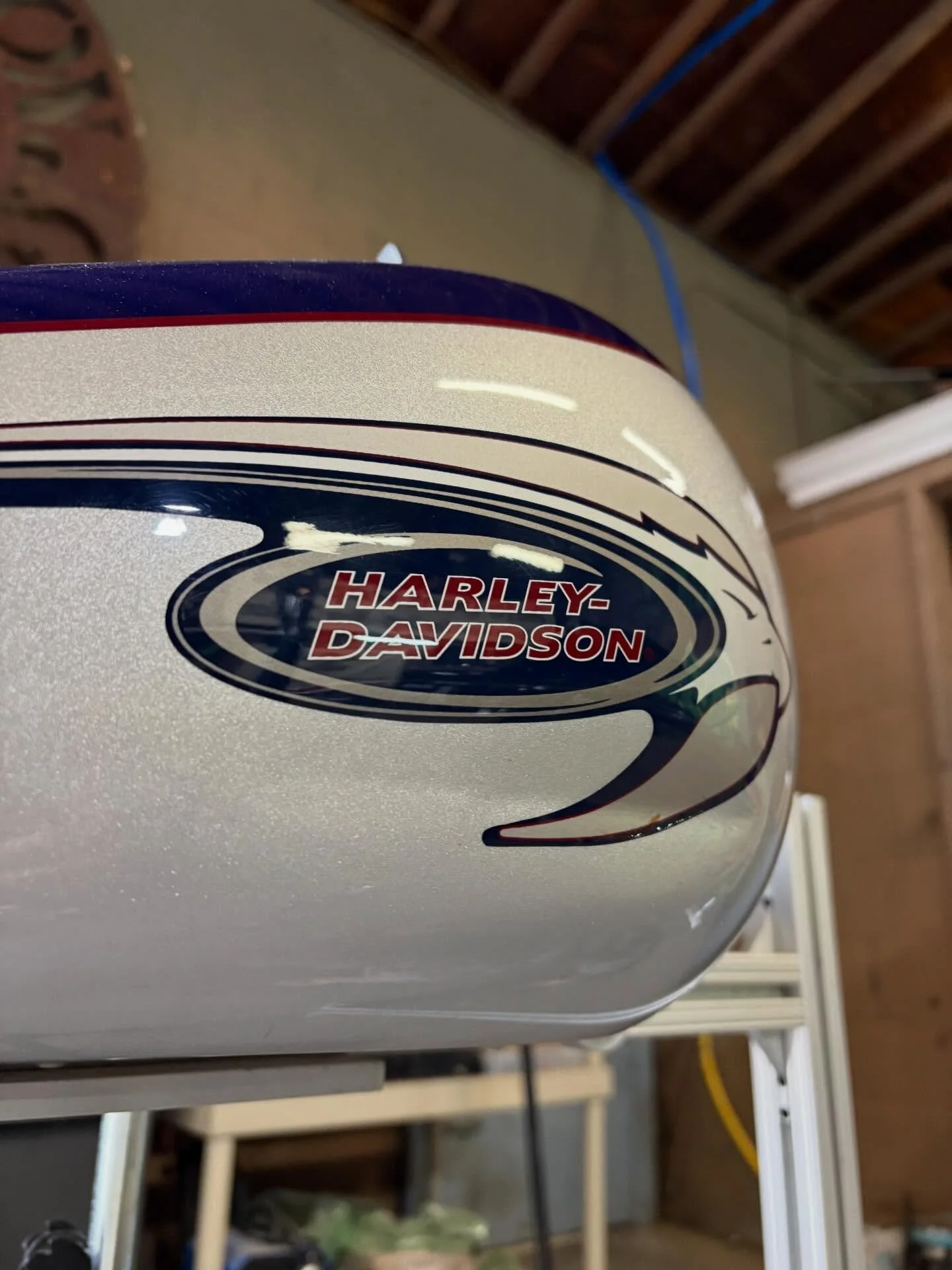 Harley-Davidson tank — crease repaired through the decal, factory paint preserved.