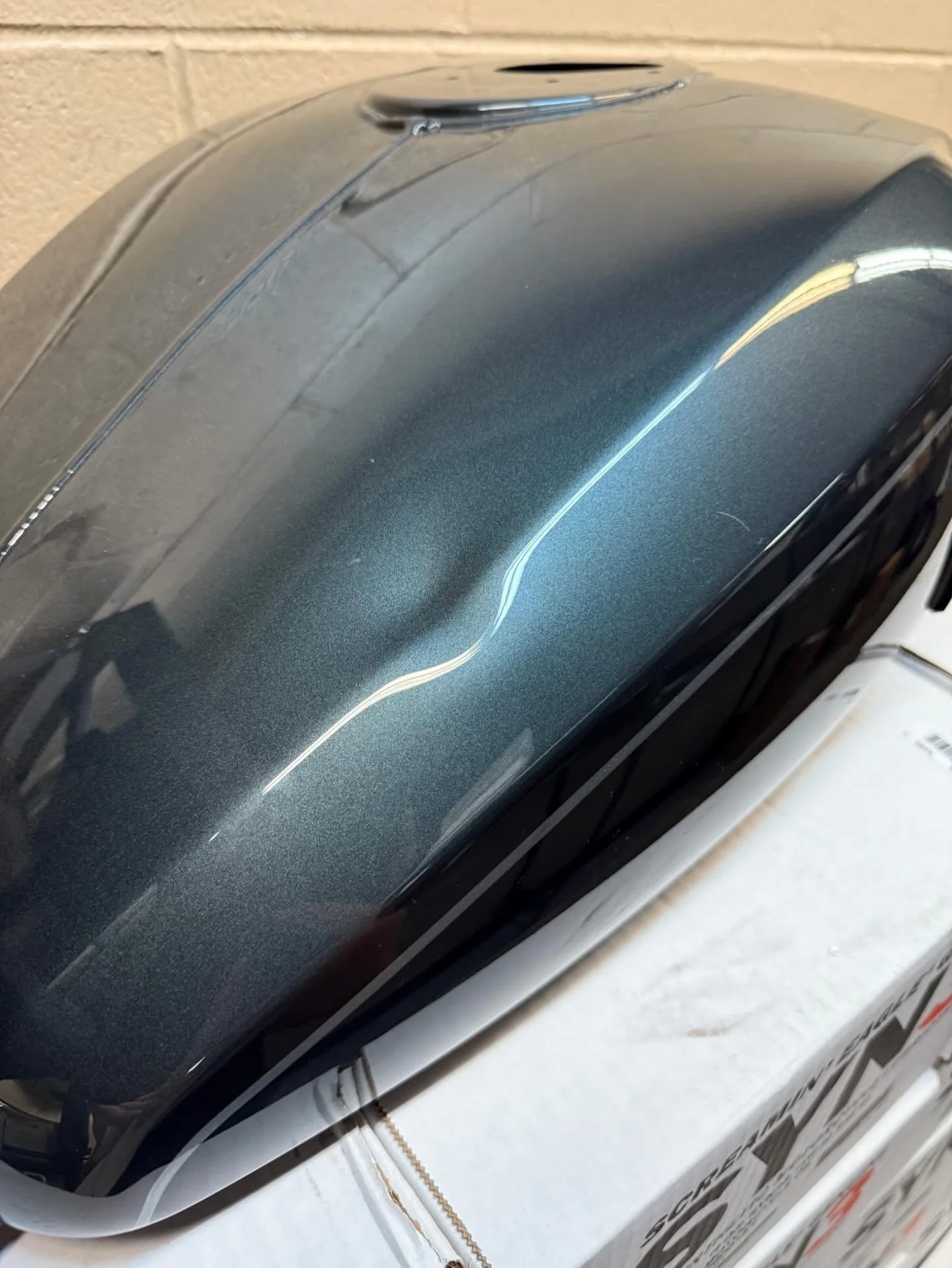 Dark Harley-Davidson tank — before: crease across the top.