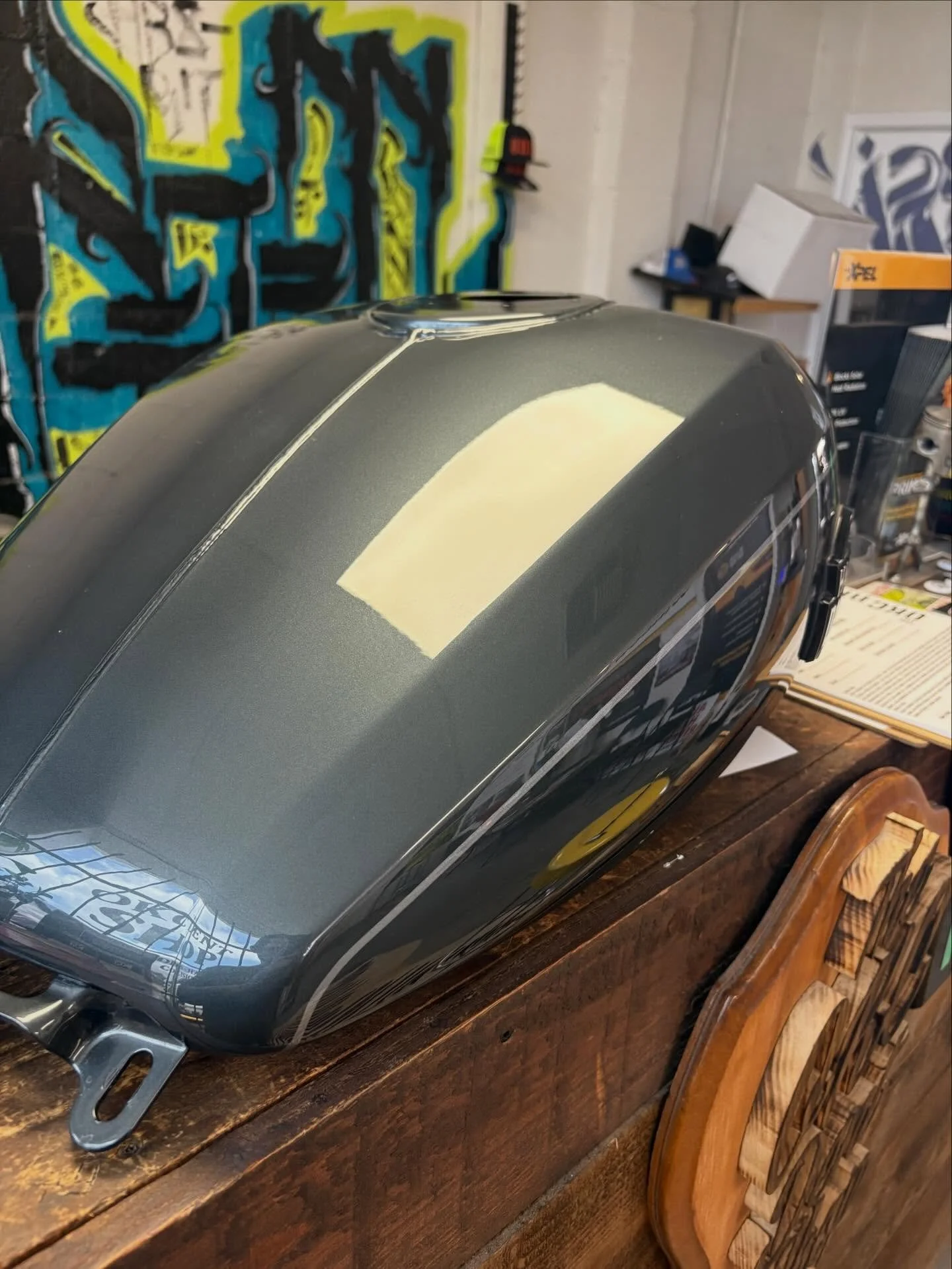Dark Harley-Davidson tank — after paintless dent repair.